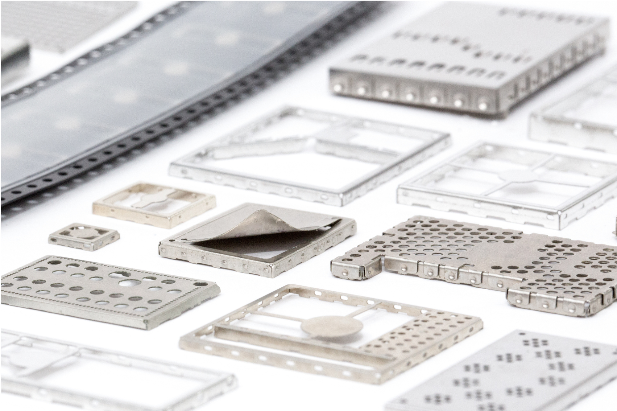 A collection of pressed metal parts on a table.